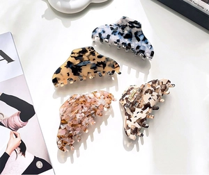 Close-up of assorted marble, tortoise, and floral pattern large acetate hair claws