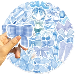 Close-up of blue plaid bow sticker with various decorative waterproof decals in background