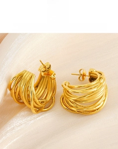 Detailed macro view of multi-layer gold-plated wire-wrapped C-shape stud earrings