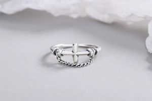 Detail of s925 silver cross ring with vintage chain texture and adjustable open band