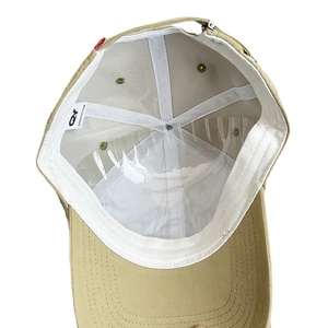 Inside view of khaki cotton baseball cap showing white sweatband and adjustable buckle