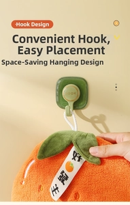 Detail of hanging coral fleece hand towel with creative persimmon design and adhesive hook