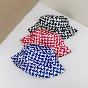 Three houndstooth bucket hats in black, red and blue colors showing textile texture