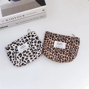 Detail of leopard print canvas pouches with smooth silver metal zipper ring pulls