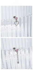 Detail of pink heart zircon earrings with silver wings and long metal chain pendants