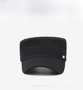 Front view of a black flat top military cap featuring a small metal side emblem