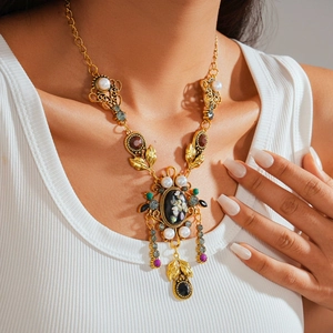 Vintage gold necklace with faux pearls and colorful gemstone pendants on model