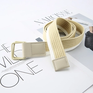 Striped canvas belt with double D-ring buckle on a fashion magazine background