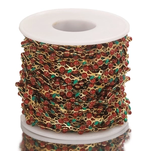 Detailed spool of gold cherry chain with red rhinestones and green enamel for jewelry making