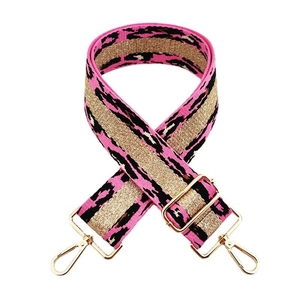 Detail of leopard print bag strap with pink texture, gold glitter thread, and metal buckle