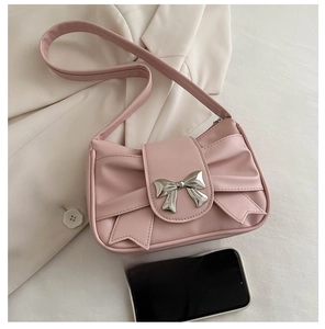 Pink pleated underarm bag with silver bow buckle and smartphone for size reference