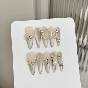 Handmade almond press-on nails with champagne cat-eye effect, pearls and large crystals