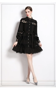 Detail of elegant black lace dress featuring stand collar and button-down hollow design