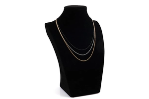 Detailed view of triple-layered minimalist necklaces in gold, silver and black finishes