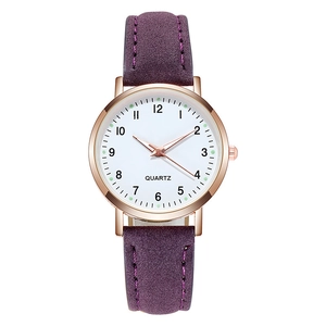 Detailed close-up of quartz watch with rose gold case and purple suede leather strap