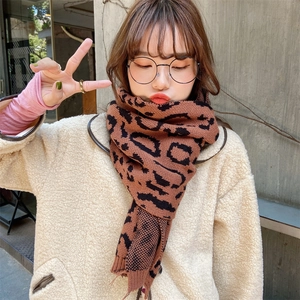 Close-up of leopard print knitted scarf texture worn with a fuzzy sherpa jacket