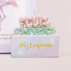 Pink and mint green gradient Feliz Cumpleaños candle with gold glitter detail and gift box