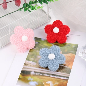 Three colorful 8cm teddy fleece flower accessories with white fuzzy centers