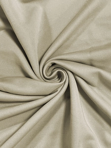 Close-up of champagne knit fabric texture showing soft spiral drape and fine weave detail