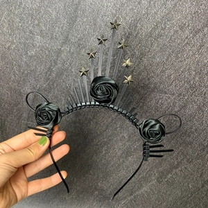 Detail of gothic black rose headband with silver stars and radiant spiked crown design