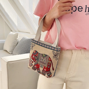 Detail of small canvas tote bag featuring vibrant elephant embroidery and ethnic patterns