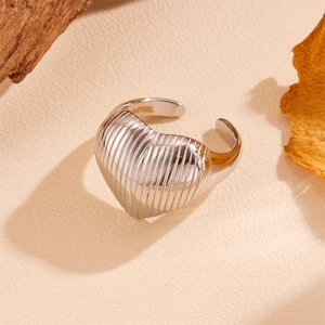 Detail of silver heart-shaped ring with vertical stripe texture and adjustable band