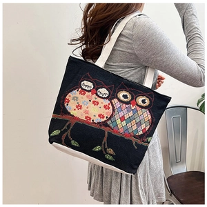 Ethnic style canvas tote bag featuring colorful owl embroidery detail with white strap