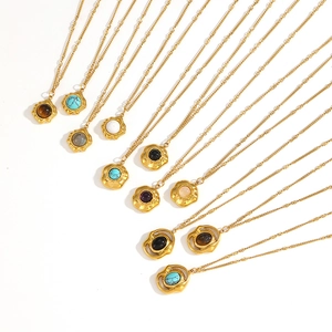 Detail of colorful tiger eye and turquoise pendants on gold stainless steel chains
