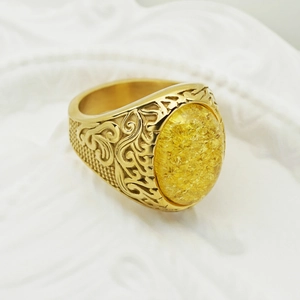 Vintage gold men's ring featuring an oval yellow gemstone with viking relief engraving