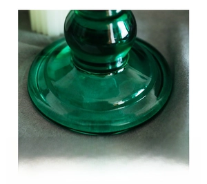 Macro detail of the stable green glass disc base for a vintage-style candle holder