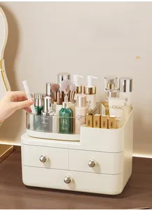 Detail of multi-compartment makeup organizer with gold drawer handles and top slots
