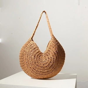 Large natural straw woven tote bag for women, circular beach shoulder bag on white stand