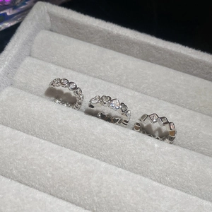 Macro view of silver rings featuring heart, round, and square cut zircon stones