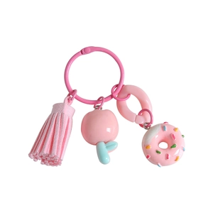 Pink resin tulip keychain set with apple and doughnut charms on a white background