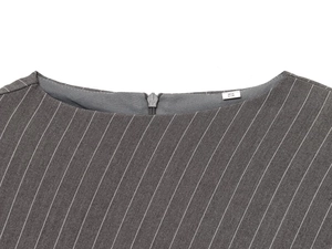 Detail view of grey pinstripe fabric texture with seamless back zipper and size S label
