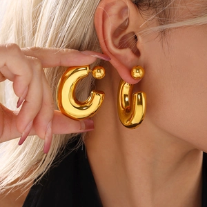 Polished chunky gold C-shaped hoop earrings in minimalist hollow metal design