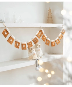 Detail of felt Christmas stockings banner with Merry Christmas letters on white shelf