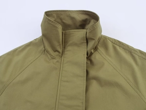 Détail du col montant et des coutures d'épaule sur la veste parka vert olive tendance