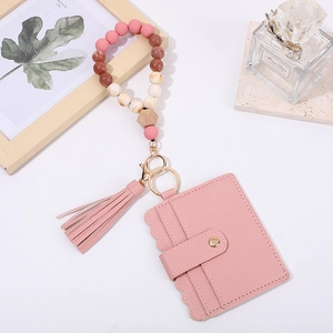 Pink leather card holder keychain with silicone beads wristlet and fringe tassel detail