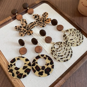 Detail of vintage leopard print resin and wood earrings displayed on a tray