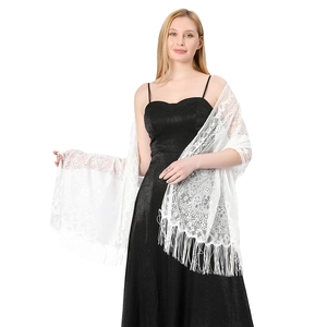Close-up of white floral lace shawl with long fringe detailing for evening dresses