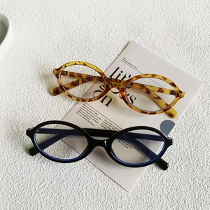 Retro oval sunglasses in amber and black on a decorative card, stylish eyewear accessory