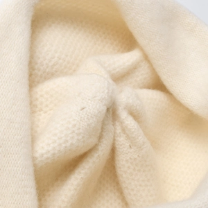 Chic cream white knitted beanie for women featuring a thick warm ribbed wool texture