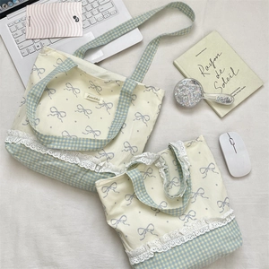 Detailed set of canvas tote bags with grey bows, lace edges and blue plaid patterns