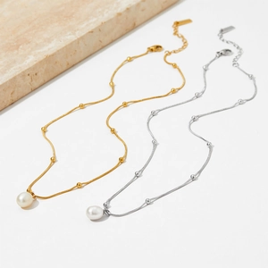 Elegant gold and silver pearl pendant necklaces on a minimalist white background