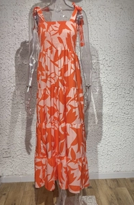 Detail of tropical leaf print dress with tiered skirt and adjustable tie shoulder straps