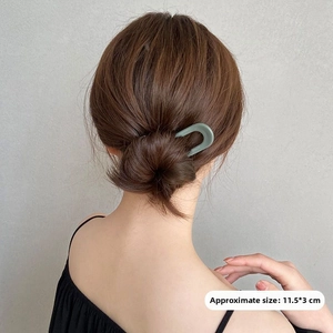 U-shaped hair pin in matte sage green showing 11.5x3cm dimensions on bun hairstyle