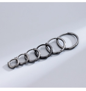 Macro shot showing six different sizes of solid black gunmetal sterling silver hoop earrings