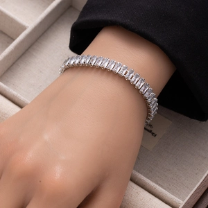 Close-up of sparkling rectangular cubic zirconia tennis bracelet on a model wrist