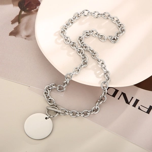 Close-up of silver titanium O-chain necklace with round disc pendant and OT toggle clasp